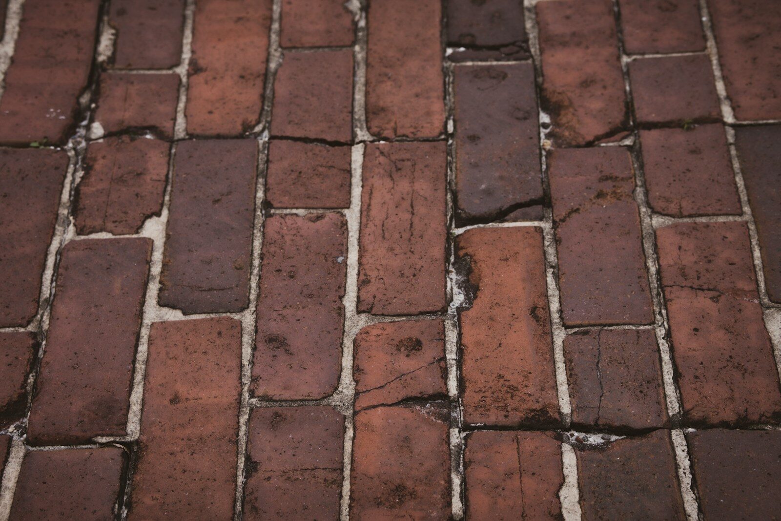A close up of a red brick sidewalk