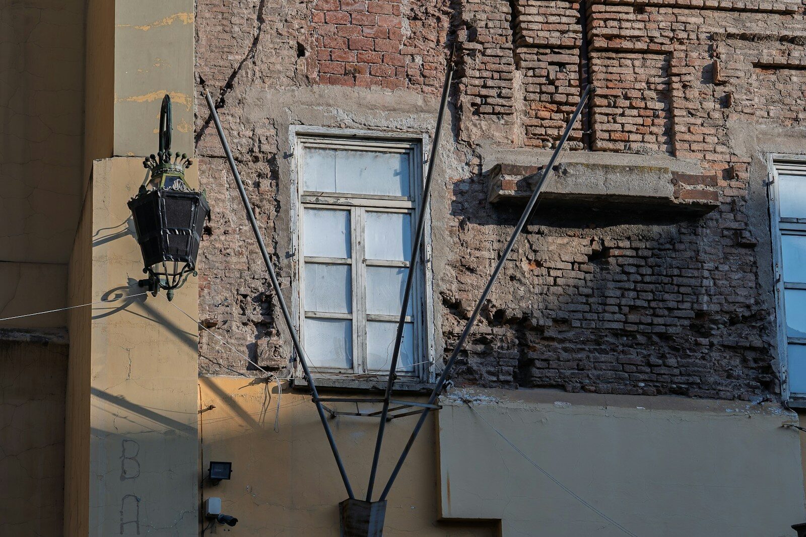 Old window on a weathered brick building facade