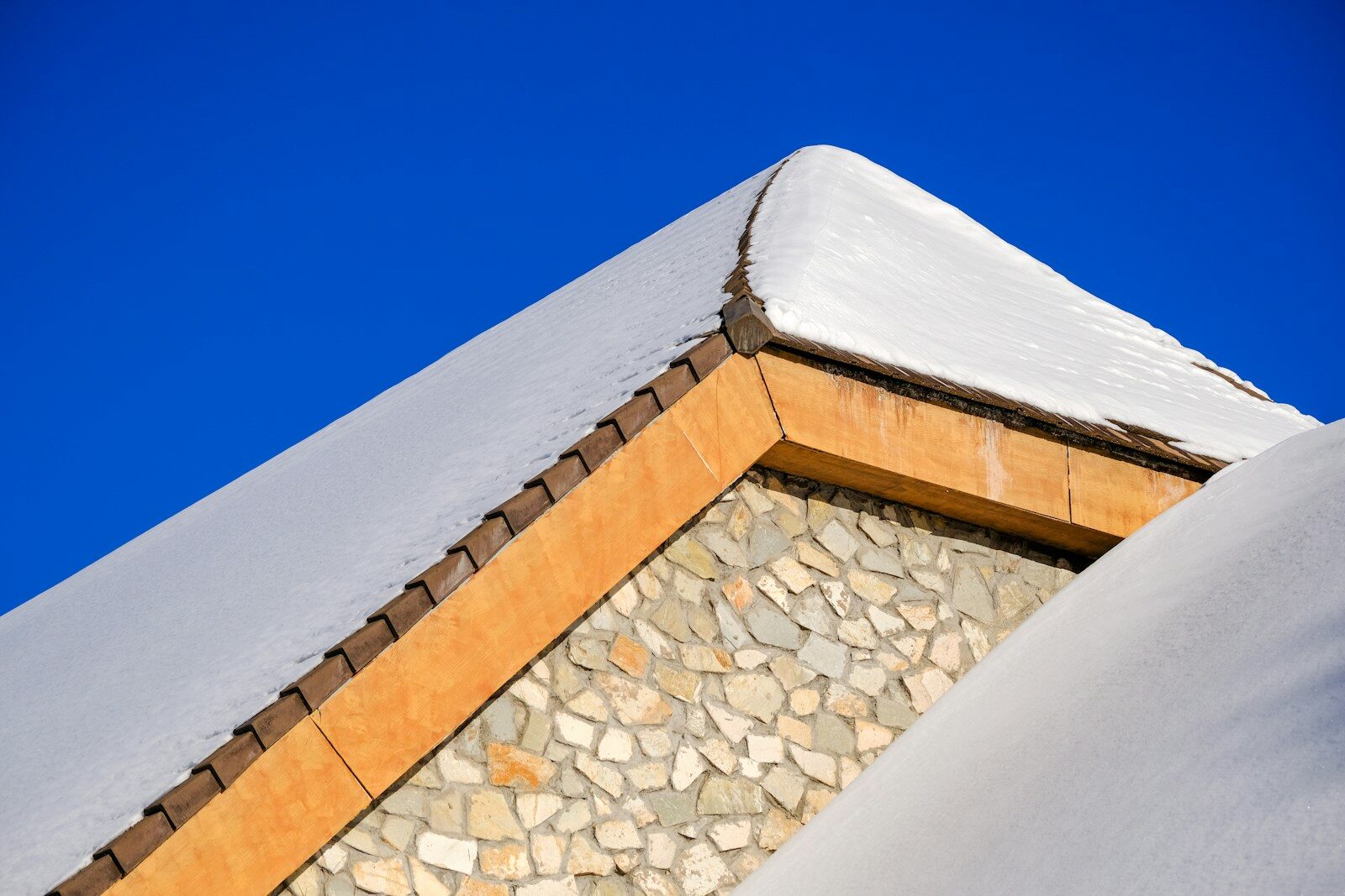 a snow covered roof with a sky background