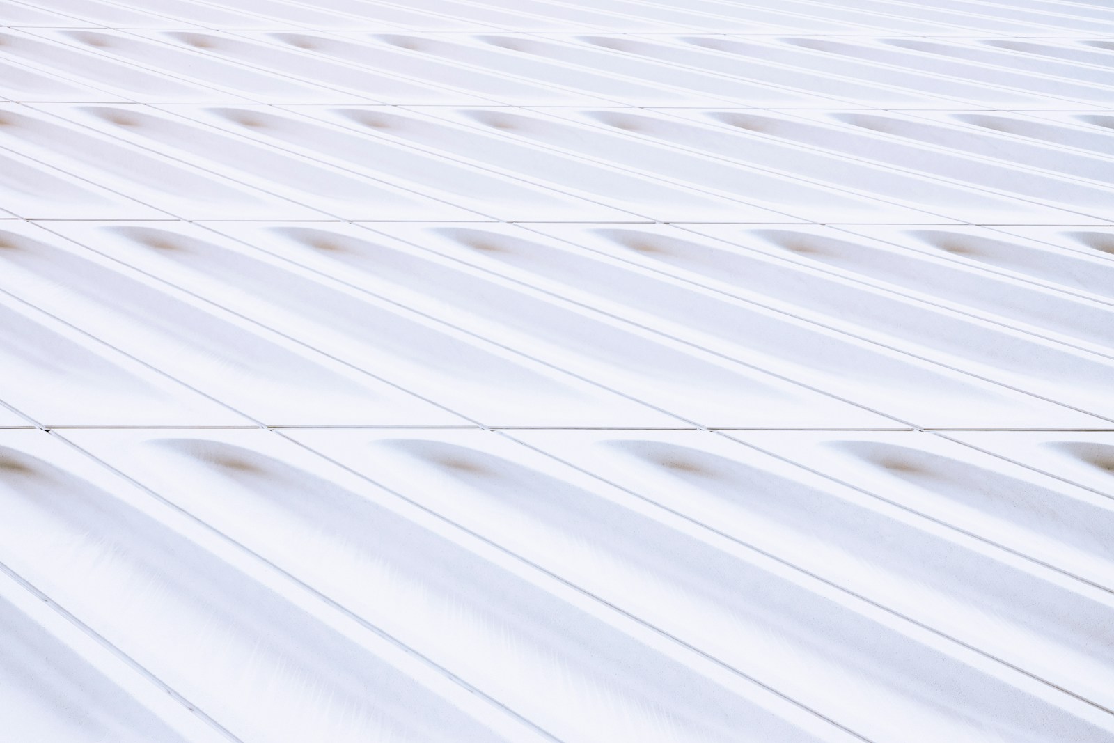 a red fire hydrant sitting on the side of a building